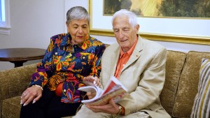 couple on couch looking over brochure