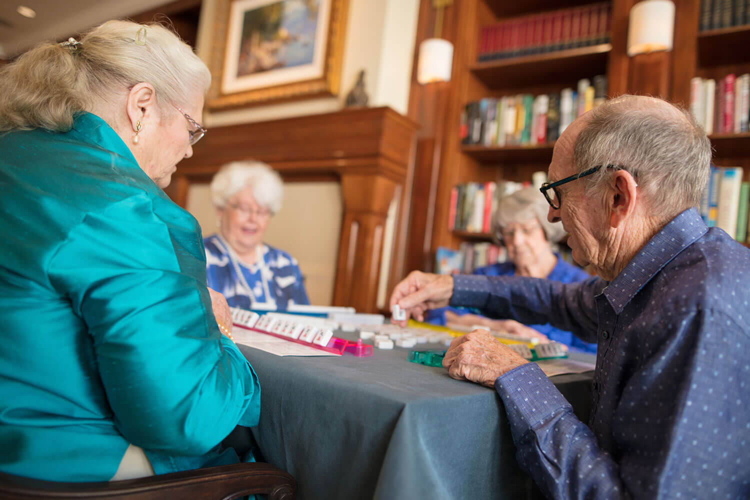 Seniors playing Scrabble together in a game room