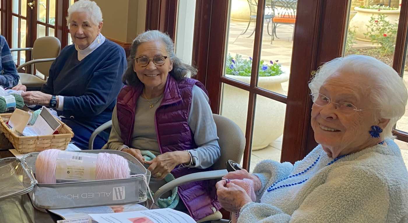 A group of senior adults knitting.